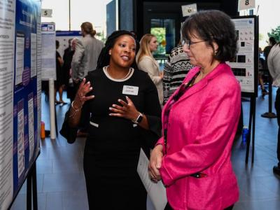 Yolanda Jackson, College of Communication and Information Ph.D. student and TL1 Scholar, shares her Alzheimer’s screening research with NIH Director Monica Bertagnolli. Jeremy Blackburn, Research Communications