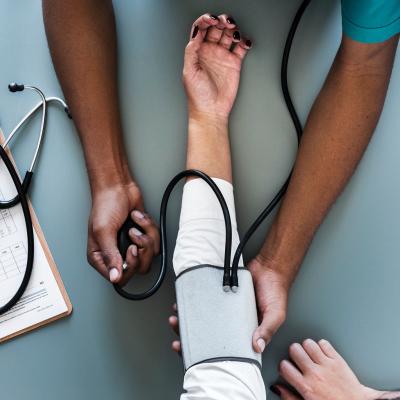 Patient having blood pressure taken with chart and stethoscope to the side
