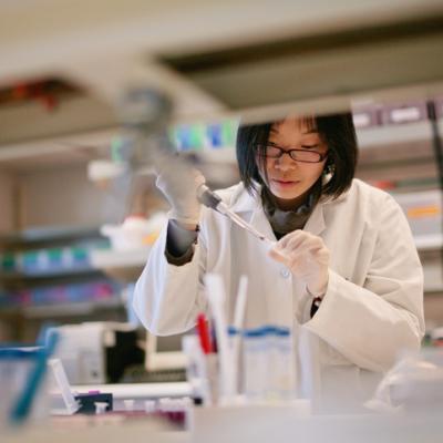 Scientist Pipetting at a Biomedical Laboratory